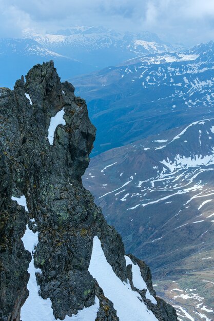 Overcast mountain view with stony rock above precipice (near Kaunertal Gletscher on Austria-Italy border)