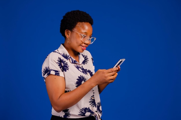 Overexcited lady with her phone isolated over blue background
