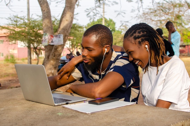 Overexcited youths smiling at what they saw on their laptop