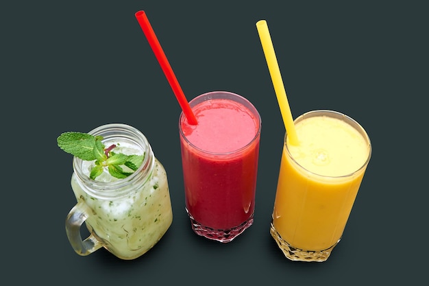 Overhead close up shot of three different kind of smoothie. Isolated on Grey with clipping path