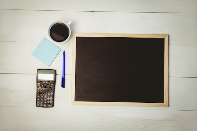 Overhead of desk with chalkboard and calculator