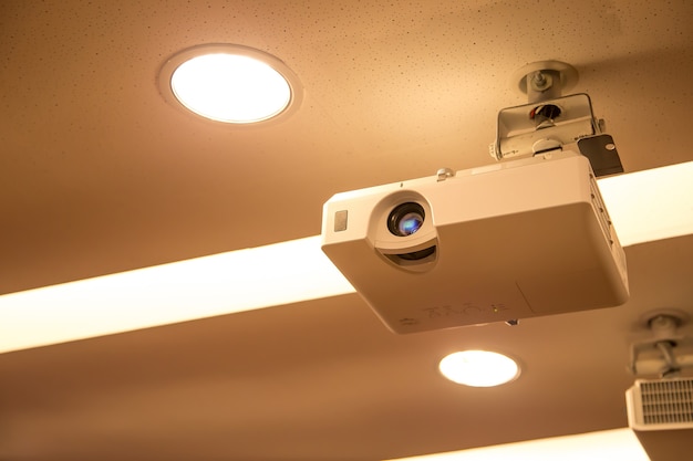 Overhead digital projector mounted on the ceiling of the\
boardroom.