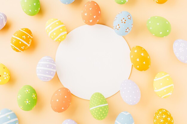 Overhead easter eggs and circle white paper isolated on pastel background