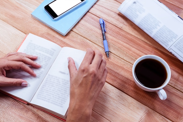 Overhead of feminine hands holding a book