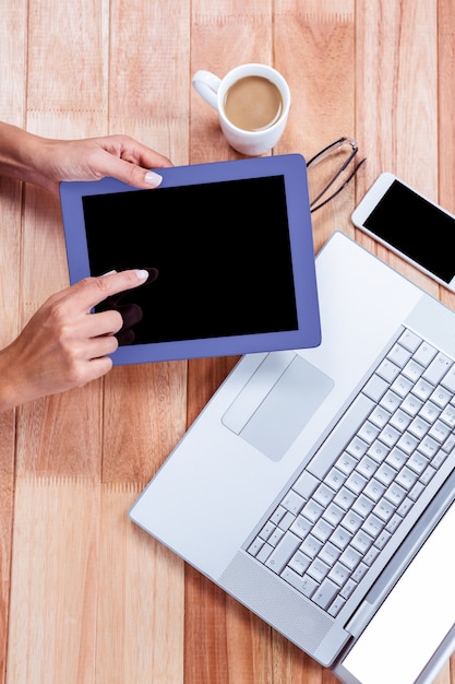 Overhead of feminine hands using tablet