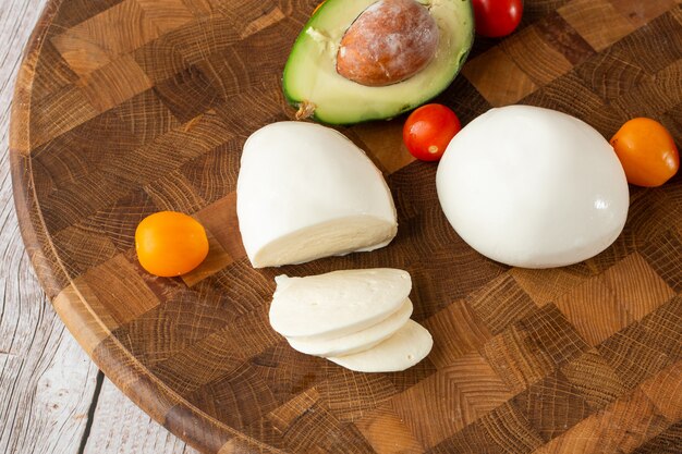 Overhead photo of buffalo mozzarella cheese with cherry tomatoes