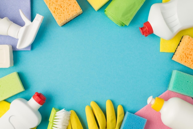 Overhead photo of equipment for cleaning isolated on the blue background with copyspace