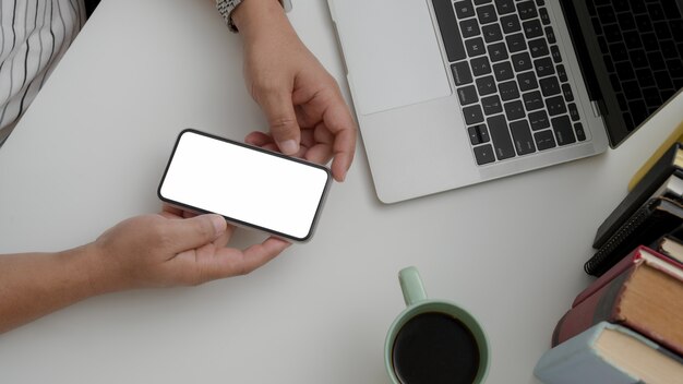 Overhead shot of male holding blank screen smartphone