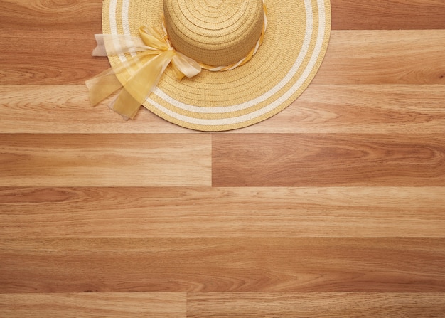 Overhead Straw hat on wooden desk