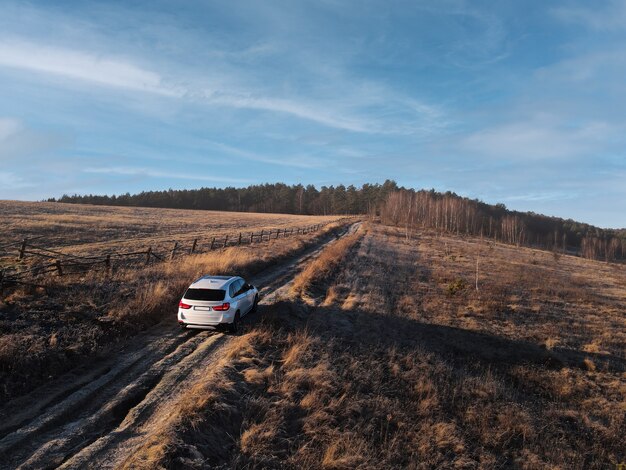 Overhead top view of the suv car going by trail road copy space