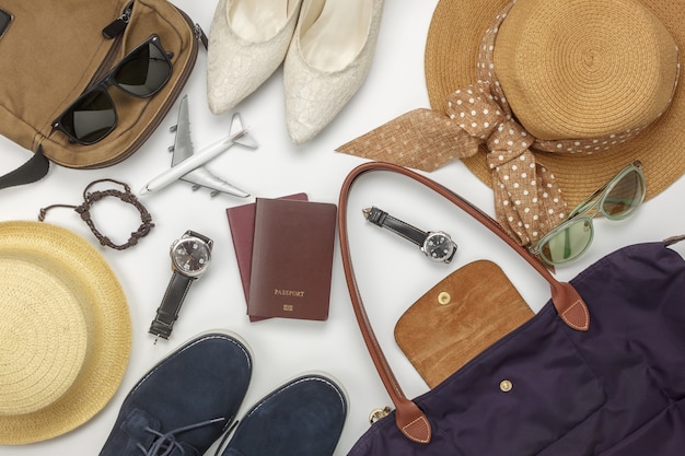 Overhead view of accessory travel and fashion men&women concept background.Difference objects for adult or teenage and traveler.Essential items for trip on the white wooden at home office desk.