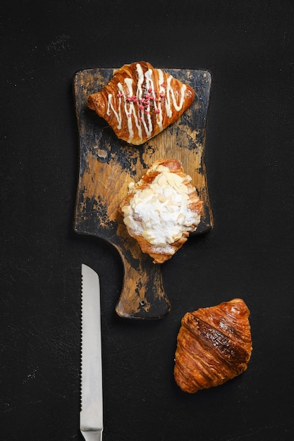 Overhead view of assortment of croissants on serving board