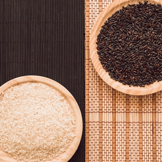 overhead view of brown and white rice grains on placemat