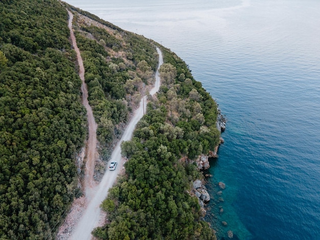 Overhead view of car moving by road next to sea shore