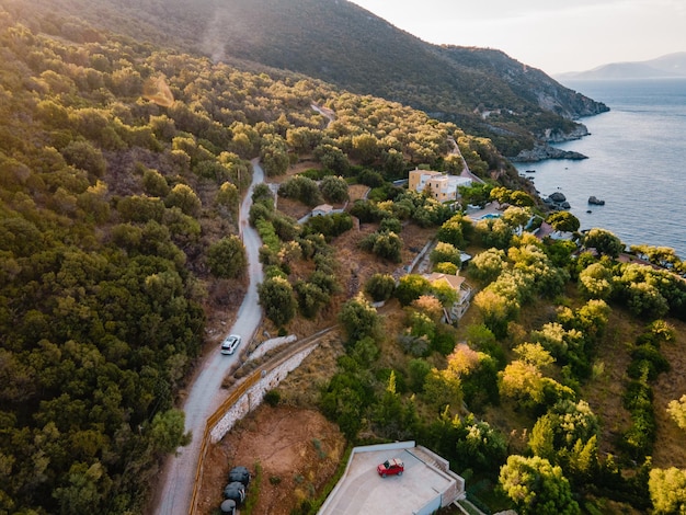 Overhead view of car moving by road next to sea shore