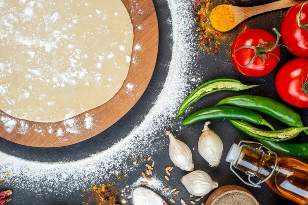 Overhead view of circle dough and vegetables