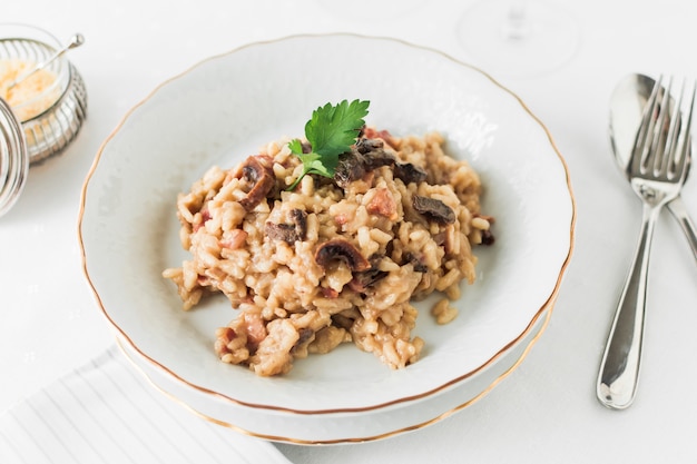 An overhead view of delicious mushroom risotto in white plate