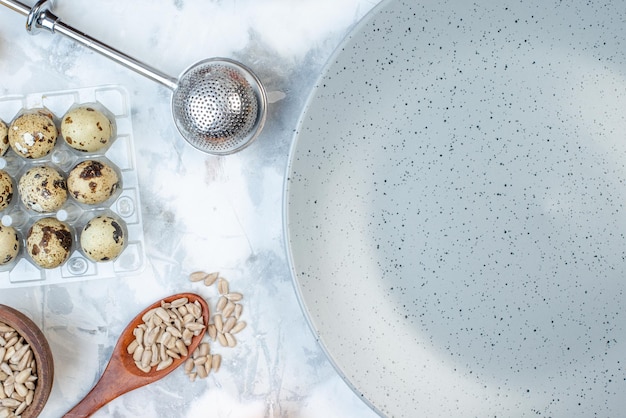 Overhead view of empty gray plate and eggs on ice background