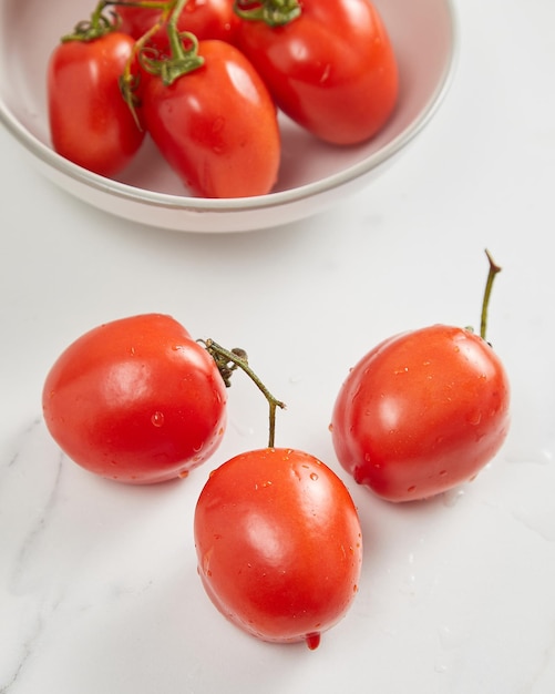 Overhead view of fresh tomato in white bowl