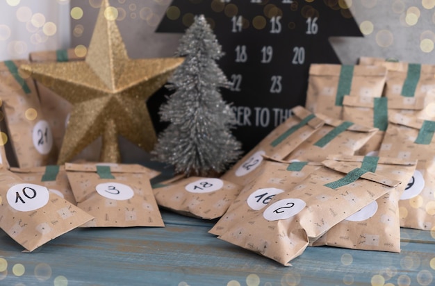 Overhead view of gifts for an advent calendar next to Christmas decorations