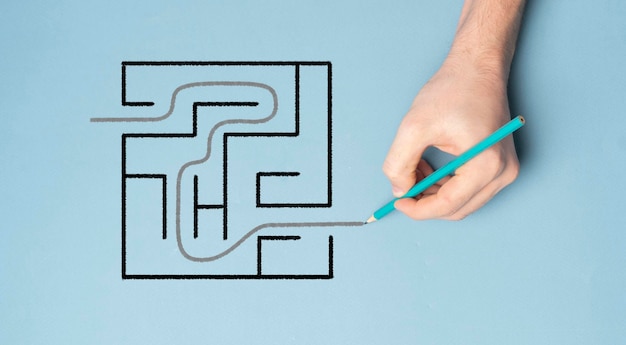 The overhead view of hand solving a labyrinth task concept of success