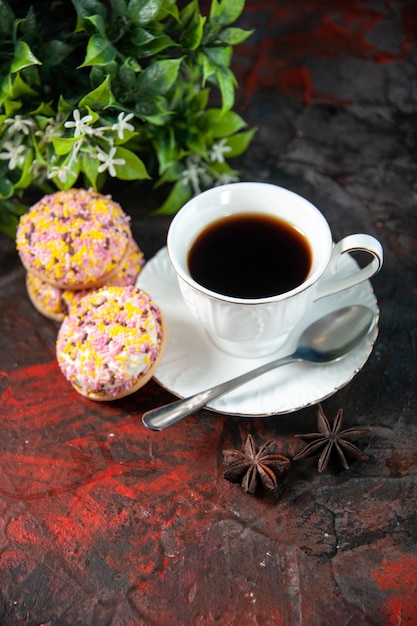 Overhead view of homemade delicious sugar cookies and a cup of coffee flower pot on dark mix colors background with free space