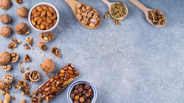 An overhead view of ingredients for making energy bar on concrete background