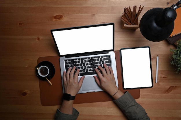 Overhead view man using laptop computer on wooden table