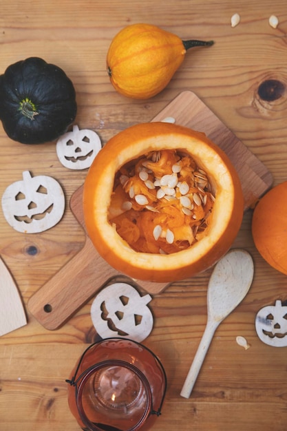 Overhead view of an orange pumpkin being carved into a lantern for halloween decoration