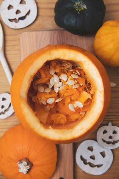 Overhead view of an orange pumpkin being carved into a lantern for halloween decoration