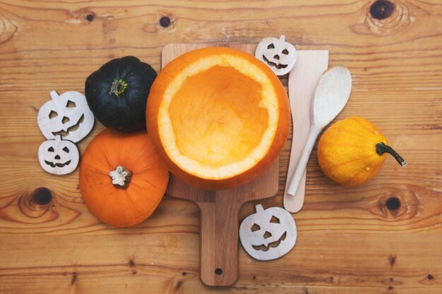 Overhead view of an orange pumpkin being carved into a lantern for halloween decoration