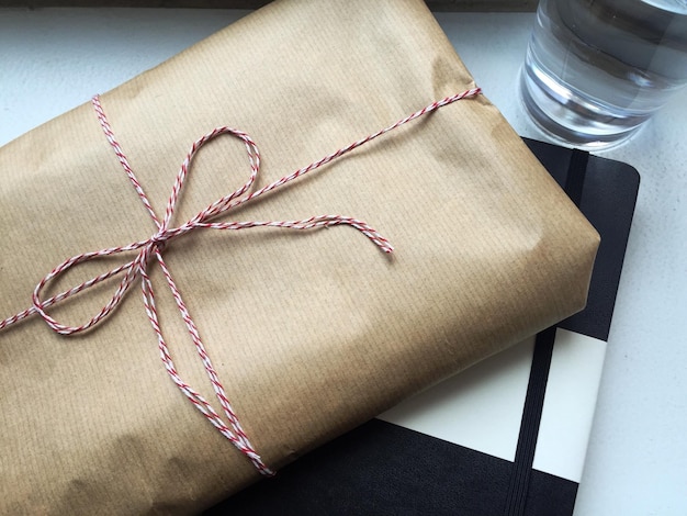 Overhead view of package and book on table