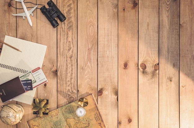 Overhead view of Traveler's accessories Essential vacation items, and Different objects on wooden wall. Travel concept wall