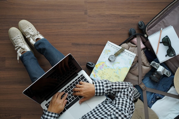 Overhead view of traveler woman plan with working laptop computer