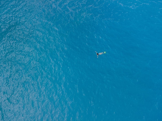 Overhead view of woman swimming in flippers