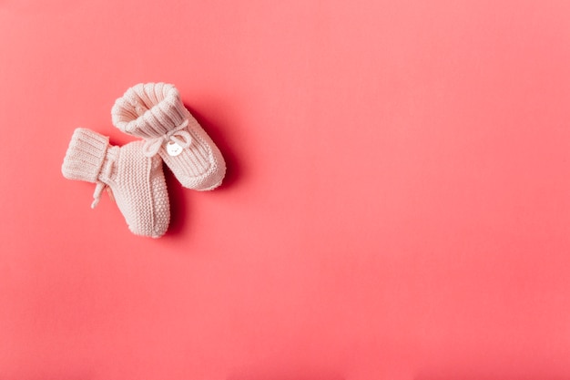 An overhead view of woolen baby's socks against bright background