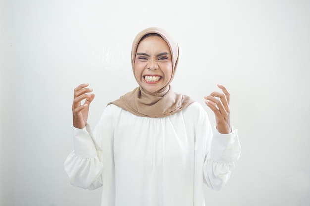 Overjoyed beautiful Asian woman celebrating big luck and success isolated over white background