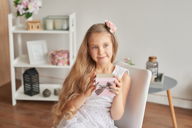 Overjoyed little girl holding present