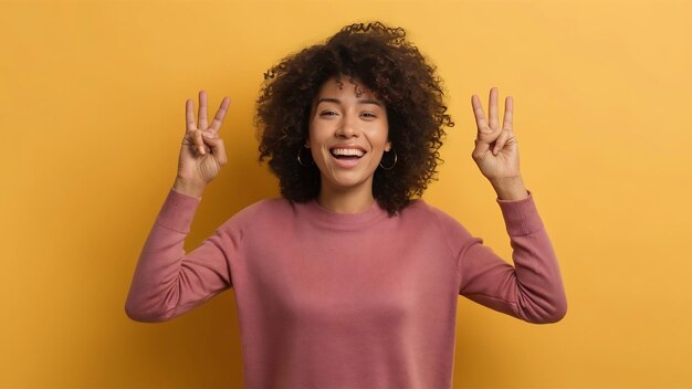 Overjoyed positive curly haired woman makes yes gesture cheers and celebrates success wears scasual