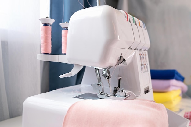 Overlock sewing clothes  using a sewing machine at home Seamstress working