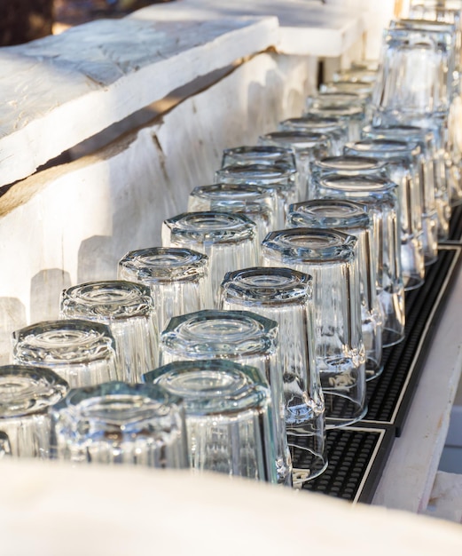 Перевернутые стаканы на деревянной белой барной стойке