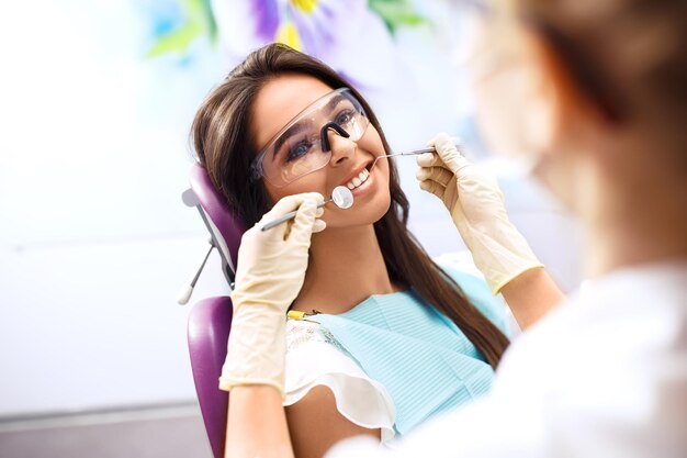 Overview of dental caries prevention Woman at the dentist's chair during a dental procedure.