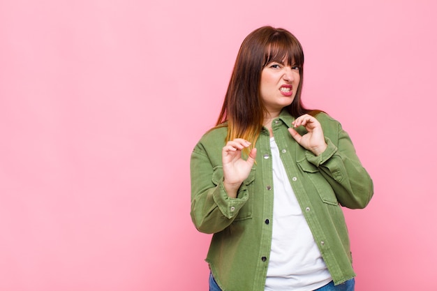 Overweight woman feeling disgusted and nauseous, backing away from something nasty, smelly or stinky, saying yuck