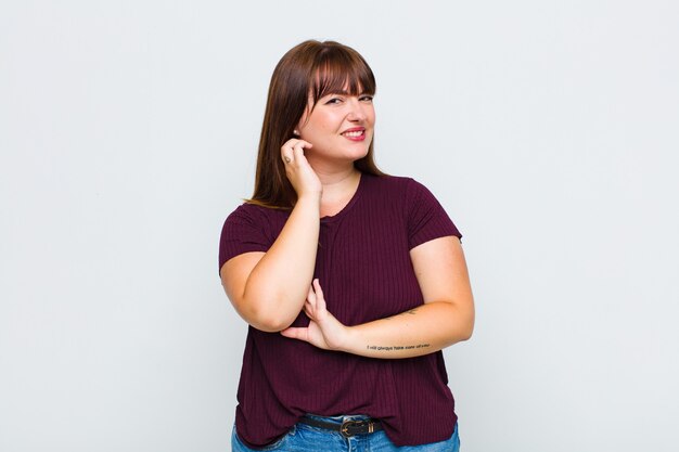 Overweight woman feeling stressed, frustrated and tired, rubbing painful neck, with a worried, troubled look