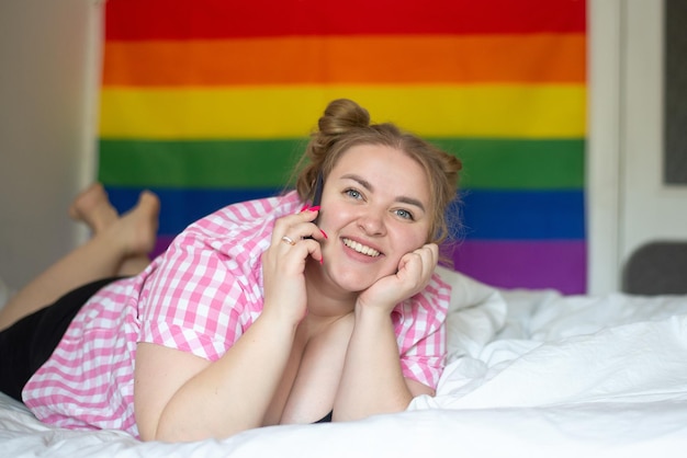 overweight woman lesbian talking on the phone the concept of bisexuality day and LGBT Pride Day