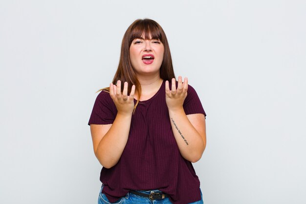 Overweight woman looking desperate and frustrated, stressed, unhappy and annoyed, shouting and screaming