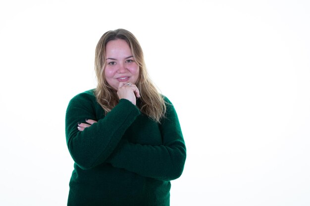 Overweight woman smiling happily and daydreaming doubting hand on chin in white copy space background