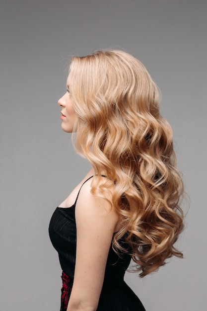 Foto overweldigende vrouw met perfect golvend blond haar.