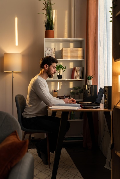 Photo overworked businessman at work. stressed millennial man feeling concentrated while sitting at workplace at home