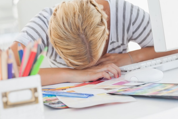 Overworked designer napping on her desk